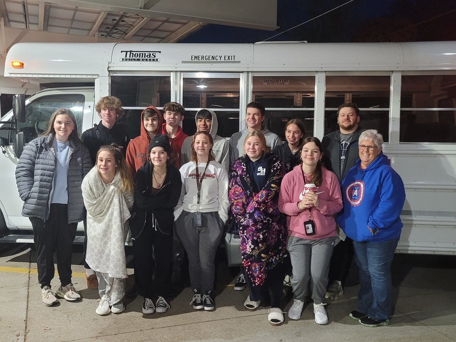 a Groups of high school teens and their chaperones from Sacred Heart School in Sedalia stops for a photo during their trip to Indianapolis to attend the National Catholic Youth Conference.